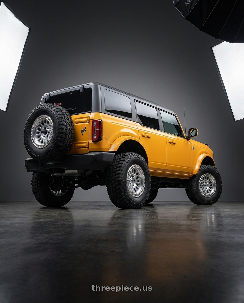 2024 Ford Bronco with KMC KM552 IMS 6X139.7 20x9 +18 GLOSS SILVER W/ MACHINED FACE wheels rear three quarter view meaty tires