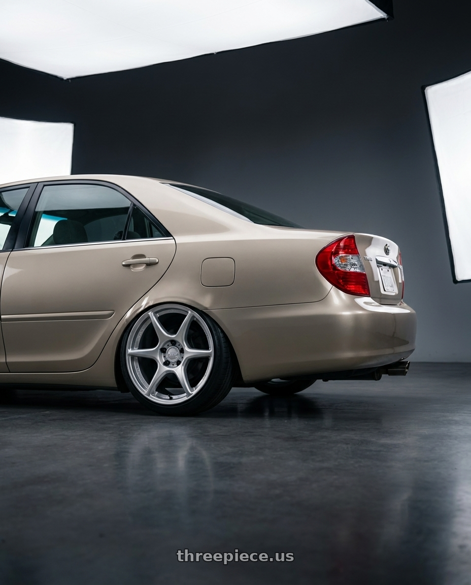 2003 Toyota camry with Kansei K11S Tandem 5x114.3 17x9 22 Hyper Silver wheels rear three quarter view slight stretch tires