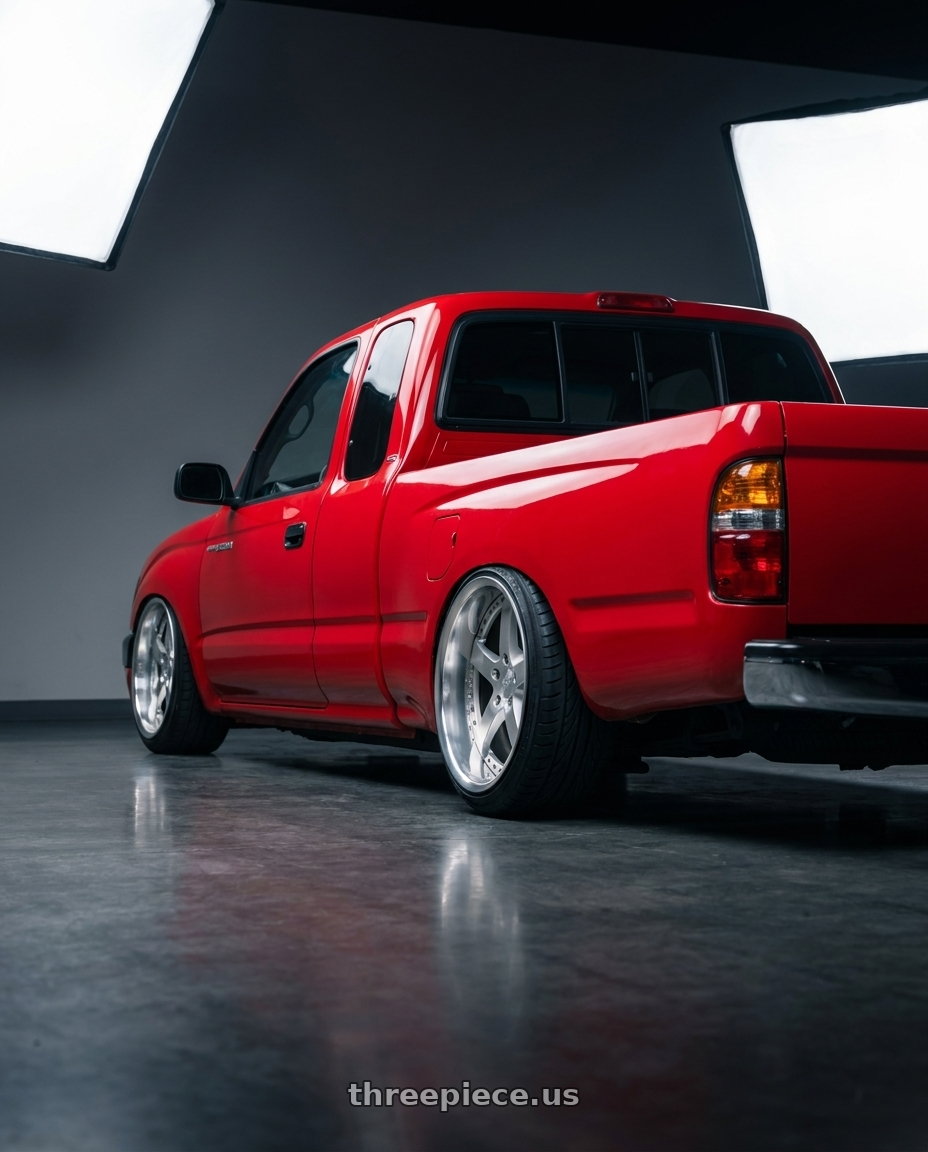 1996 toyota tacoma with Work Equip E05 5x108 19x10.5+-17 o disk Feinheit Silver 2 wheels rear three quarter view extreme stretch tires