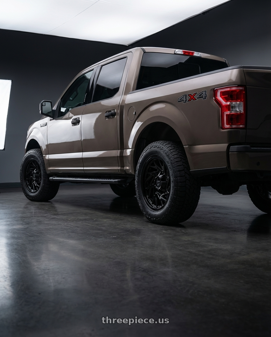 2019 Ford F-150 with Gear Off Road 769B 6X135/6x139.7 20x9 +18 Gloss Black wheels rear three quarter view meaty tires