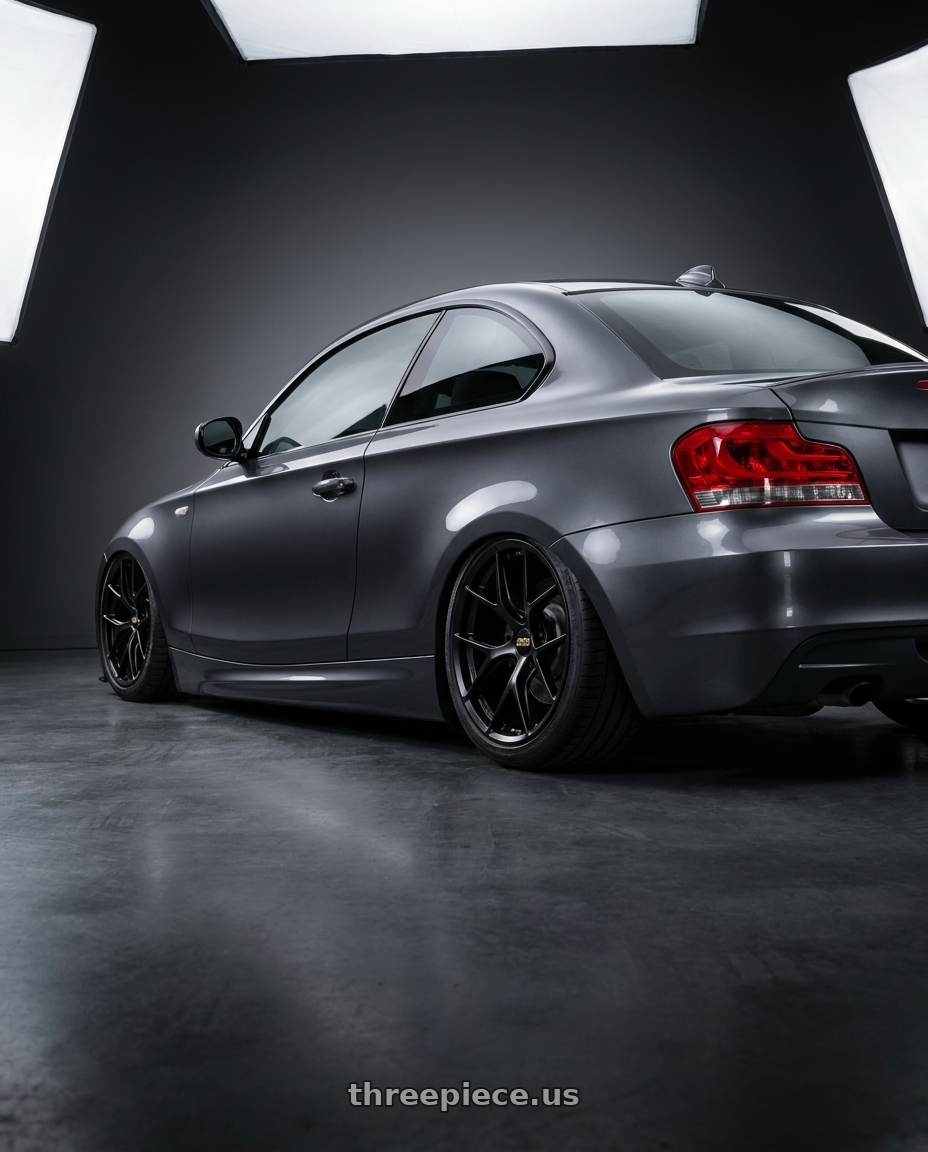 2012 BMW 1 Series E82 with BBS FI-R 5x120 19x9.5+22 Satin Black wheels rear three quarter view slight stretch tires