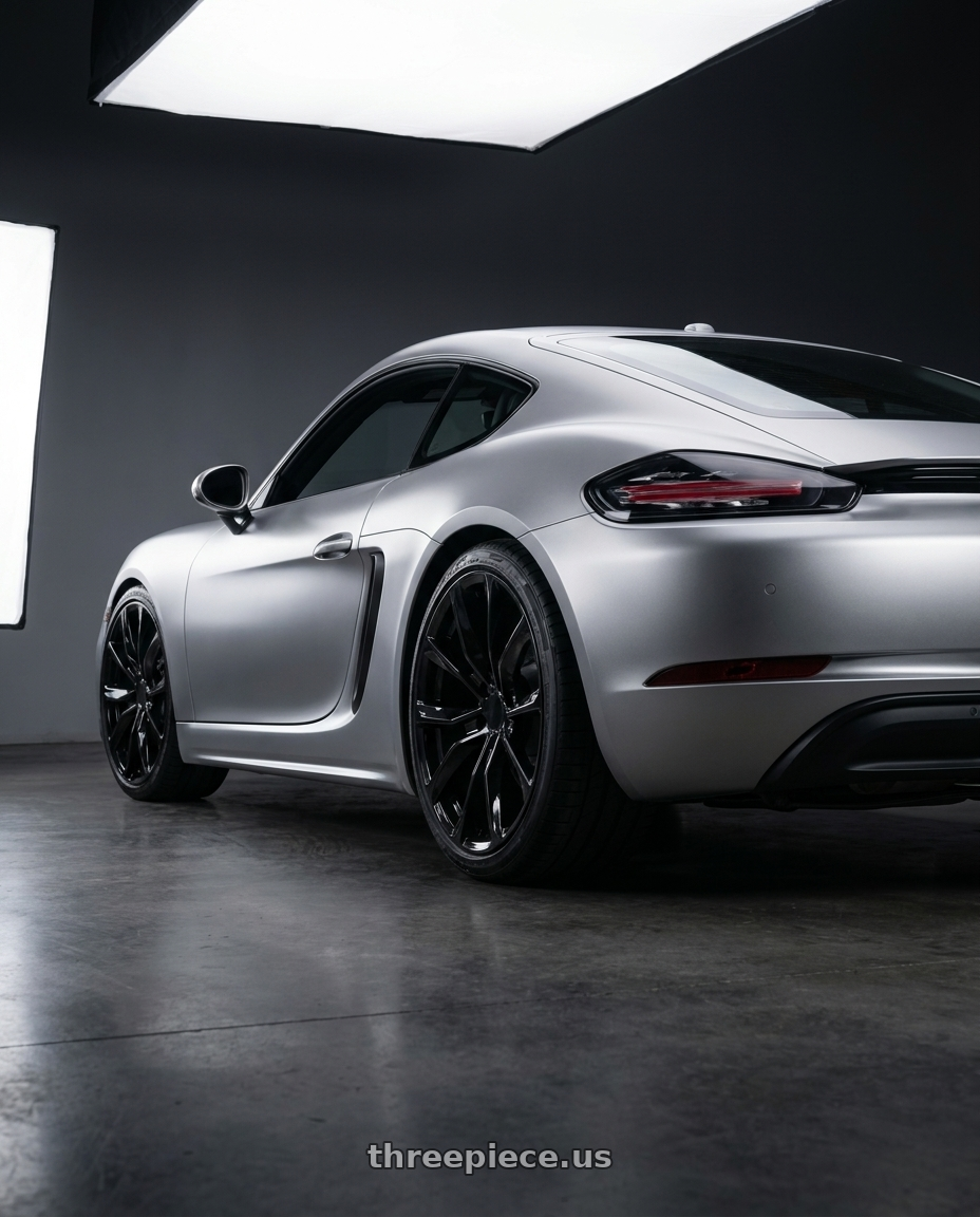 2019 cayman 718, matte silver  with REPLICA 205 6X139.7 22x9 +28 GLOSS BLACK wheels rear three quarter view square tires