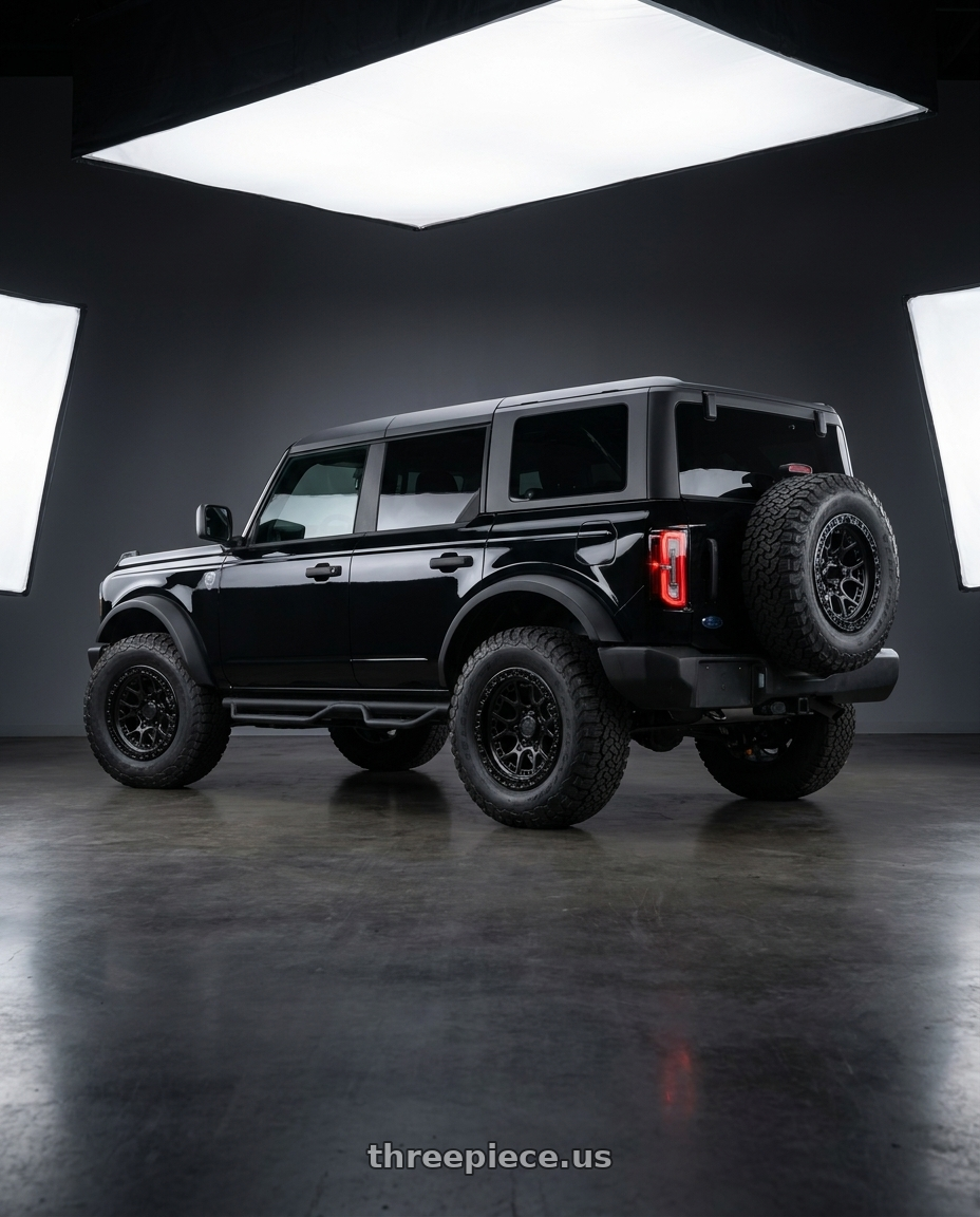 2026 Ford Bronco with LOCK OFFROAD COMMANDO 6x139.7 17x9 +12 Matte Black W Gloss Black Ring wheels rear three quarter view meaty tires