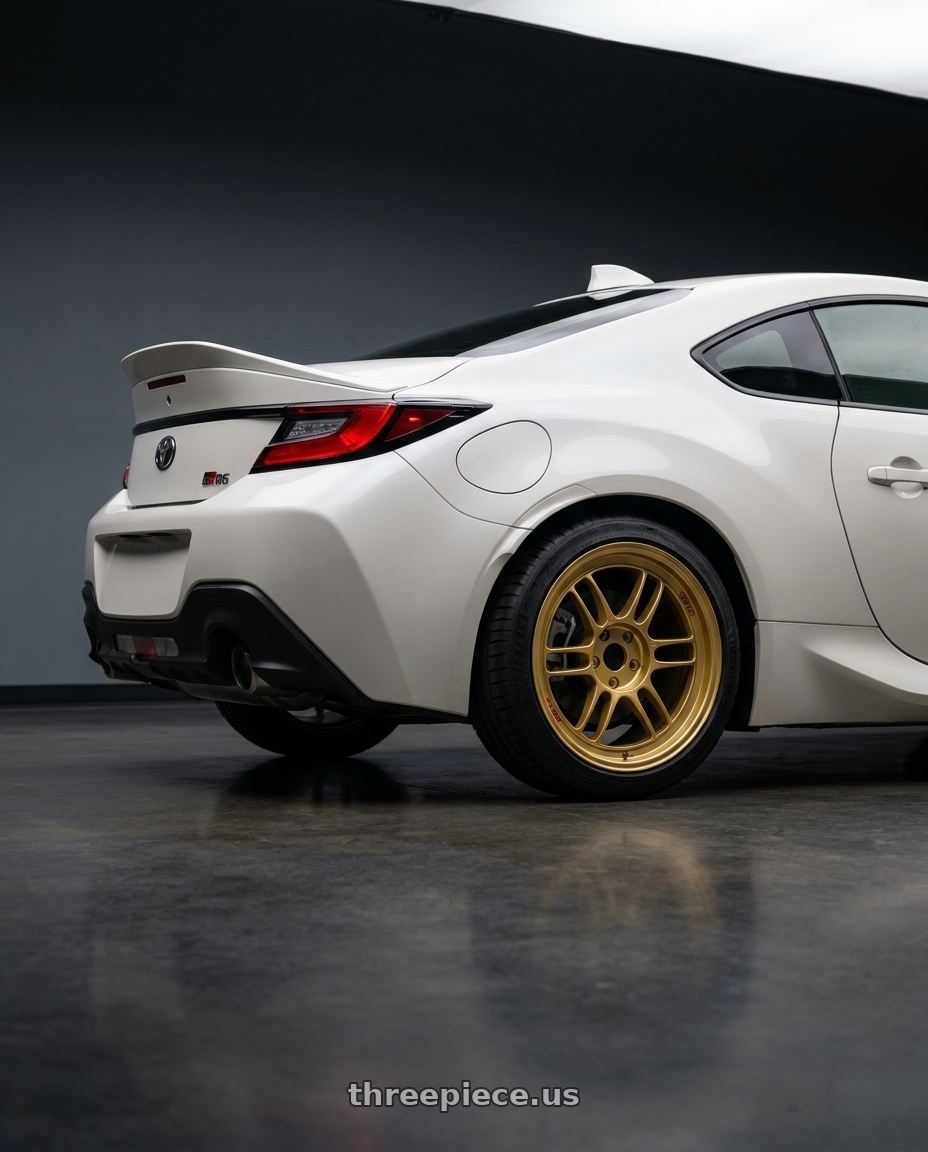 2026 Toyota GR86 premium  with Enkei RPF1 5x100 18x8+45 Gold wheels rear three quarter view square tires