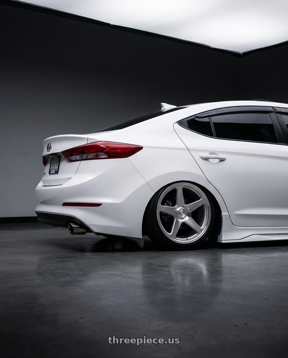 2018 Hyundai Elantra with DOLCE PERFORMANCE STELLA 5x114.3 18x8.5 +35 Gloss Silver wheels rear three quarter view square tires