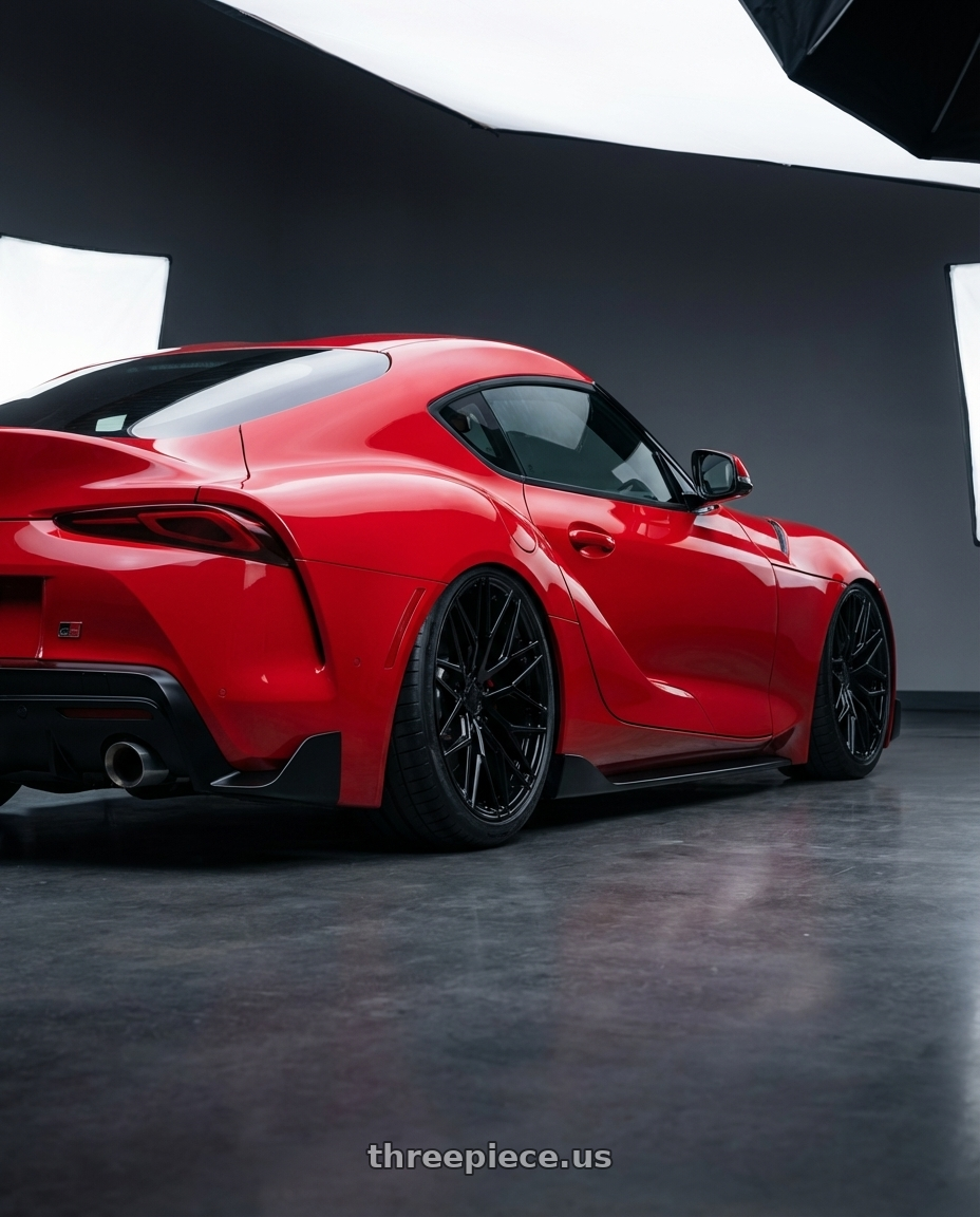 2023 Toyota GR Supra with Avant Garde Wheels M520R 5X112 19x9.5 +40 Gloss Black wheels rear three quarter view slight stretch tires