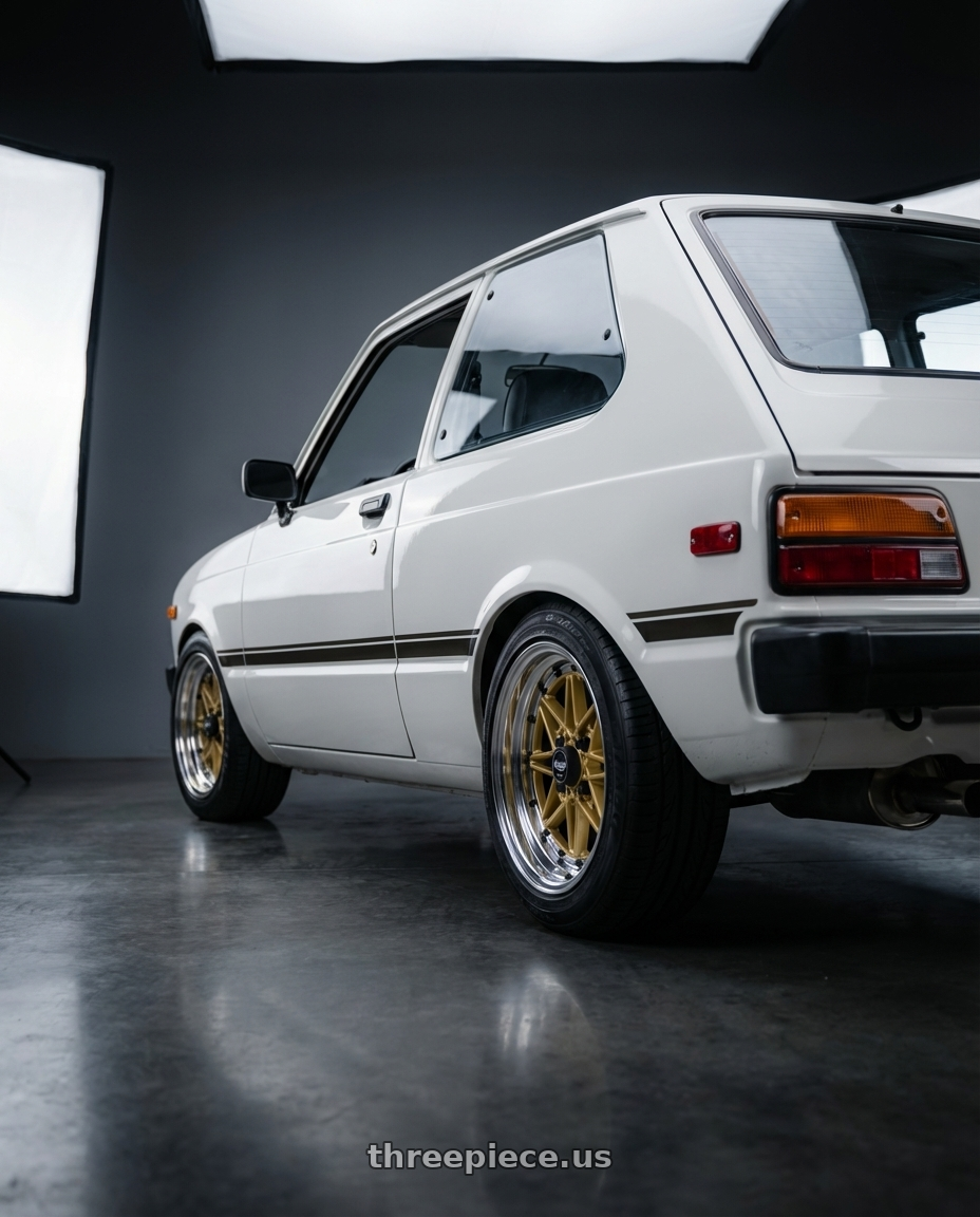 1981 Toyota starlet with EQUIP 03 GOLD 15x7 +7 wheels rear three quarter view square tires