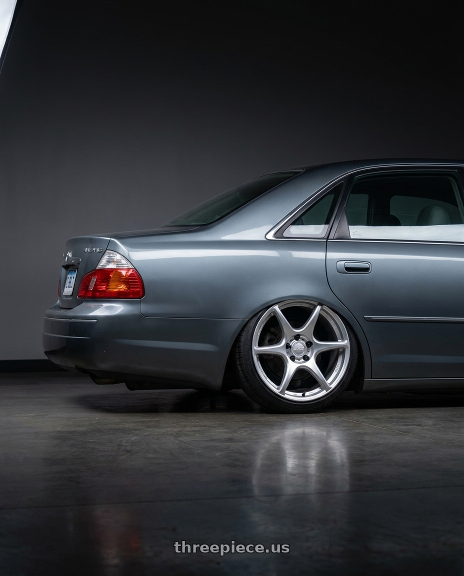 2004 toyota avaloin xls grey blue with Kansei K11S Tandem 5X120 17x9 35 Hyper Silver wheels rear three quarter view slight stretch tires