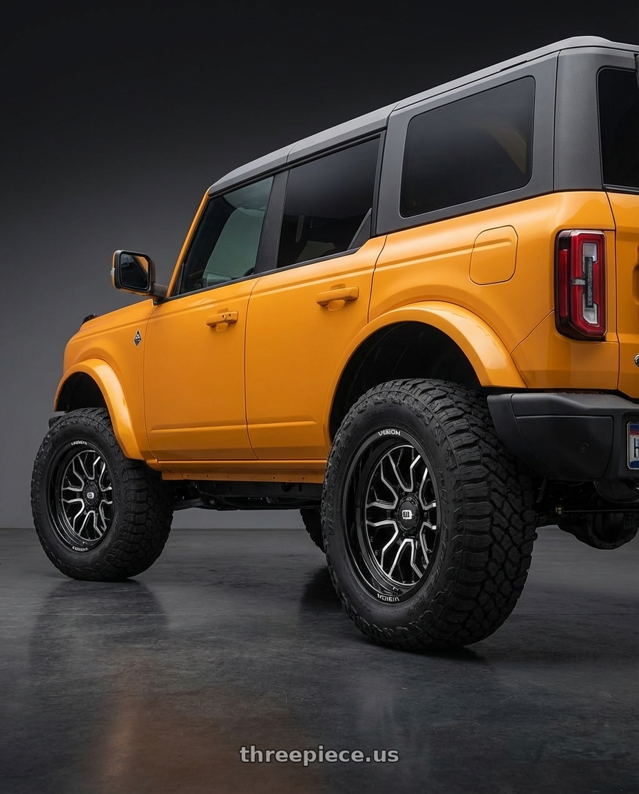 2024 Ford Bronco with Vision Off-Road 402 Riot 6x139.7 20x10-25 Gloss Black Machined Face wheels rear three quarter view meaty tires