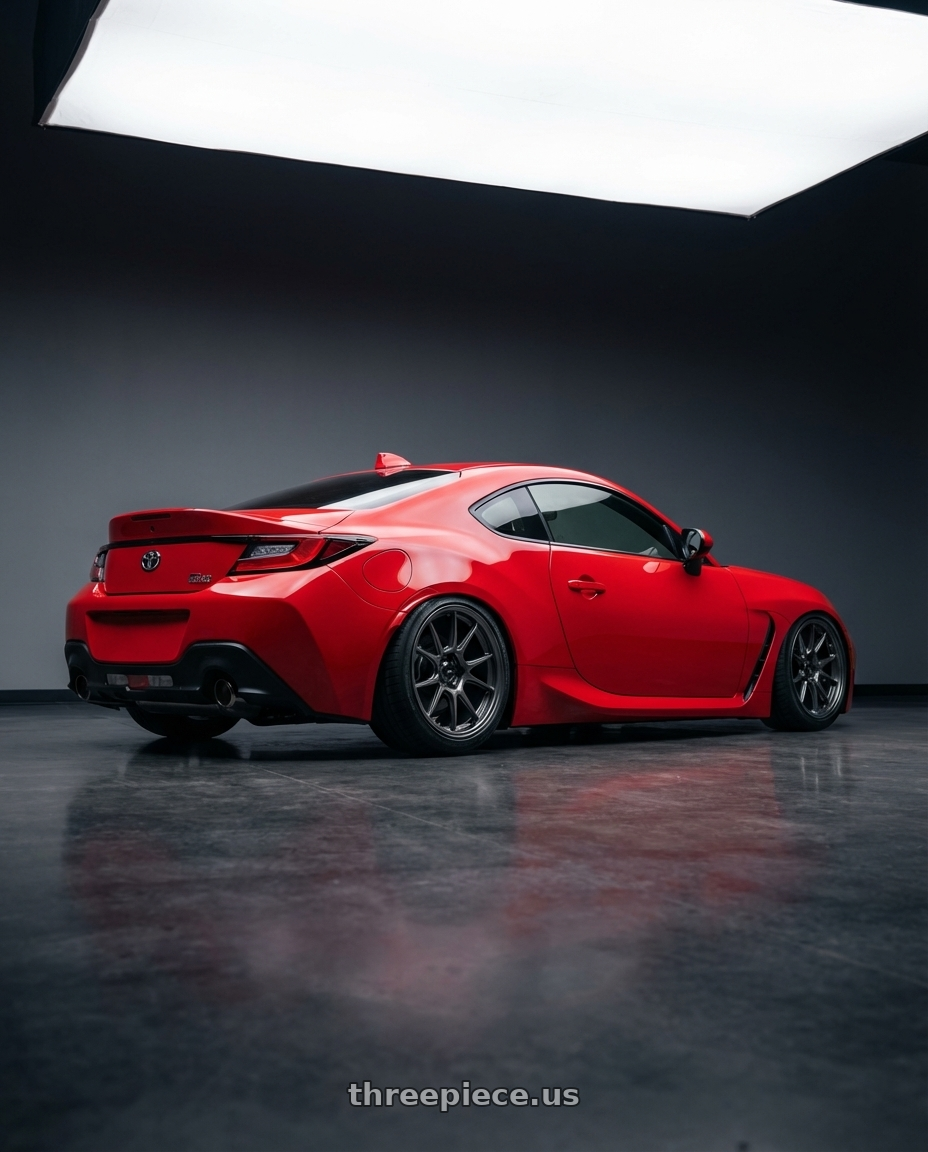 2024 Toyota GR86 with Konig Ampliform 5x114.3 18x9.5+35 Dark Metallic Graphite wheels rear three quarter view slight stretch tires