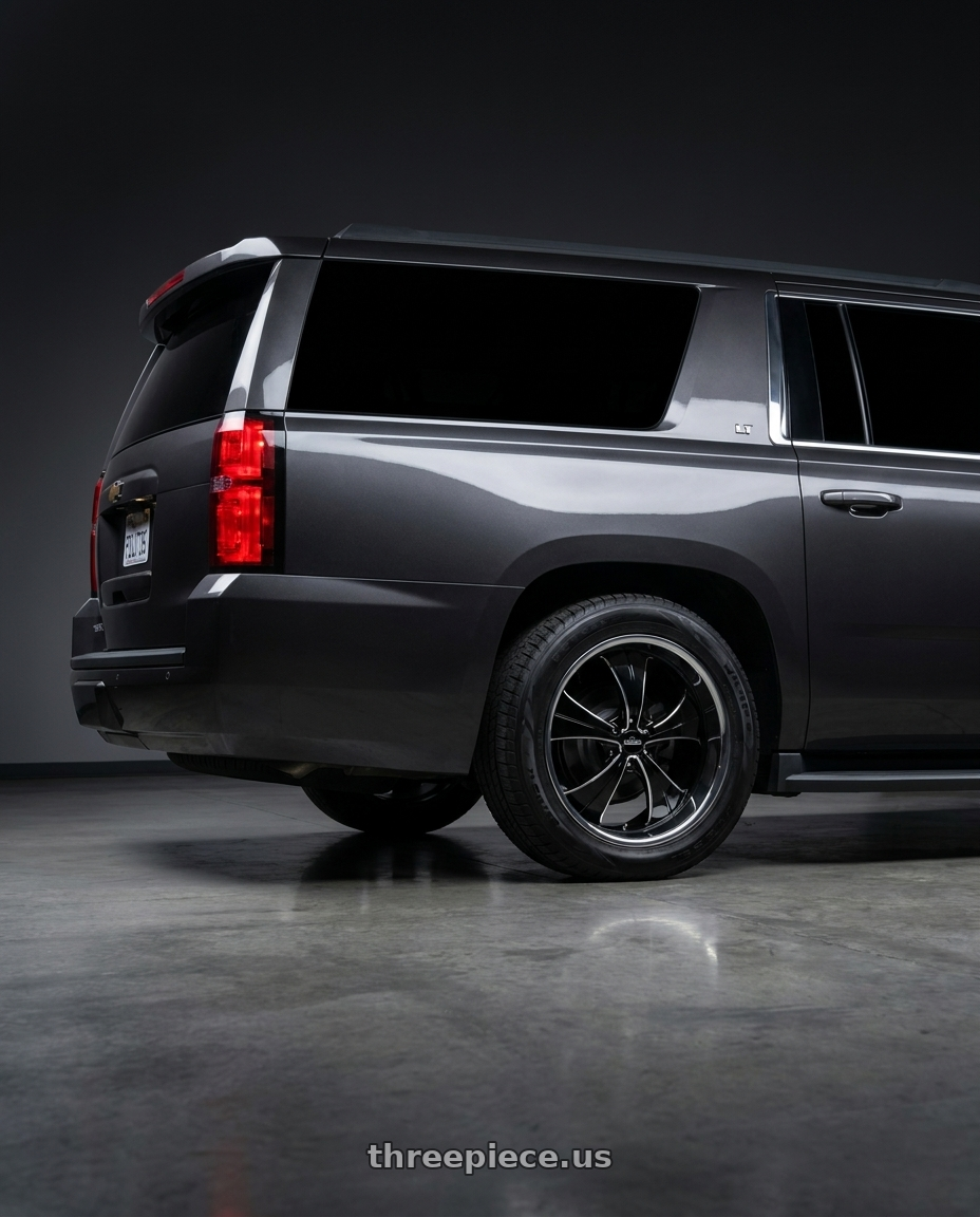 2015 Chevy Suburban LT. Dark grey  with Strada Street Classics Old Skool 6x139.7 24x10 +24 Gloss Black Milled SS Lip wheels rear three quarter view square tires