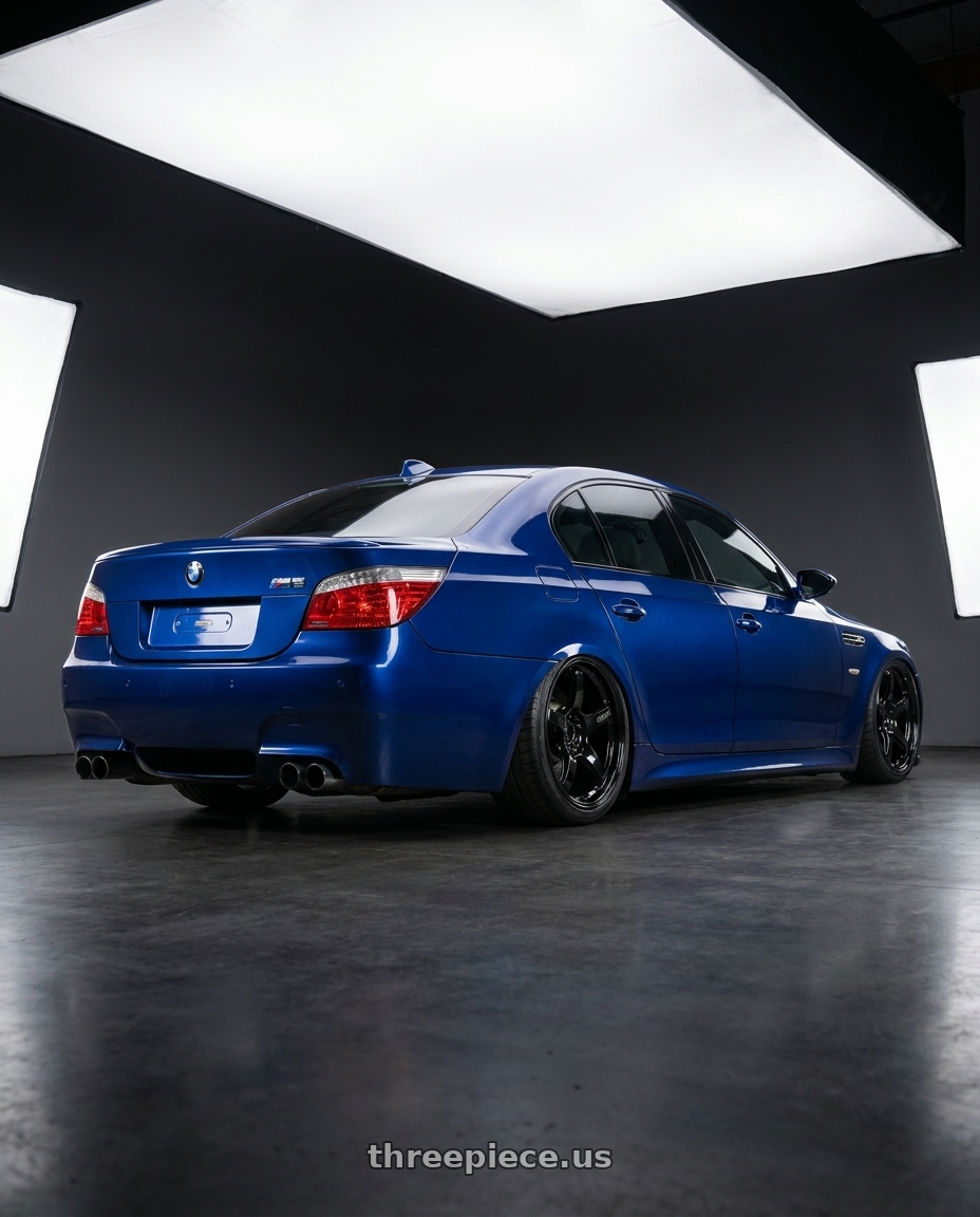 2010 BMW M5 E60 with Gram Lights 57CR 5x120 19x10.5+22 Glossy Black wheels rear three quarter view slight stretch tires