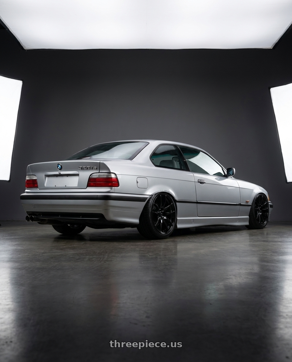 1999 BMW 328is with Vors TR4 5x120 17x9  +30 Gloss Black wheels rear three quarter view slight stretch tires