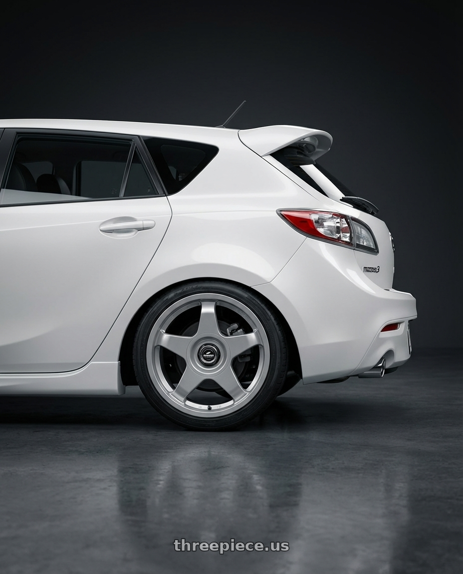 2012 Mazda Mazdaspeed3 with fifteen52 CHICANE 5x114.3 / 5x100 18x8.5 +35 SPEED SILVER (GLOSS SILVER) wheels rear three quarter view square tires