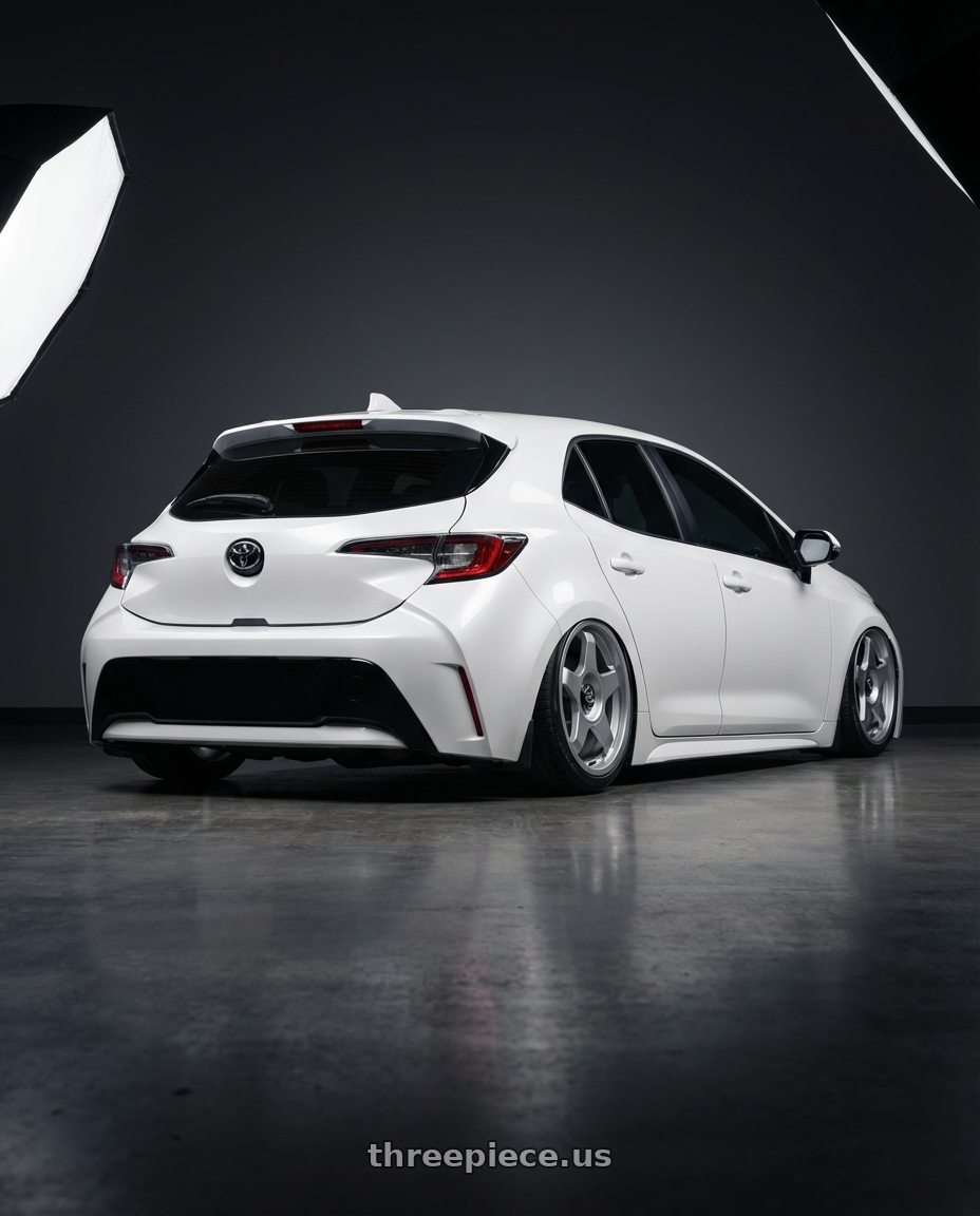 2023 Toyota Corolla Hatchback with fifteen52 CHICANE 5x114.3 / 5x100 18x8.5 +35 SPEED SILVER (GLOSS SILVER) wheels rear three quarter view slight stretch tires