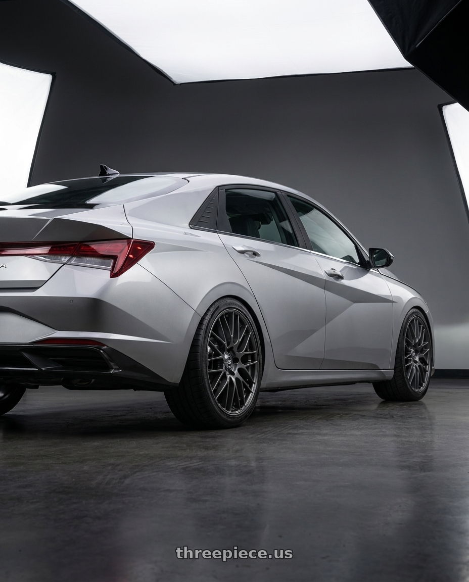 2021 Hyundai Elantra Limited with Enkei EKM3 5x114.3 18x8+40 Gunmetal wheels rear three quarter view square tires