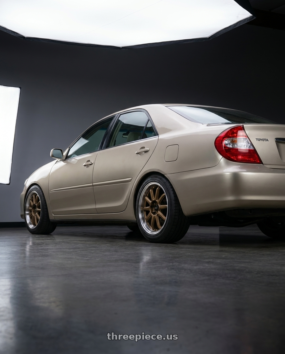2003 Toyota Camry LE with Vors SP2 5x114.3 17x8 +35 Bronze wheels rear three quarter view square tires