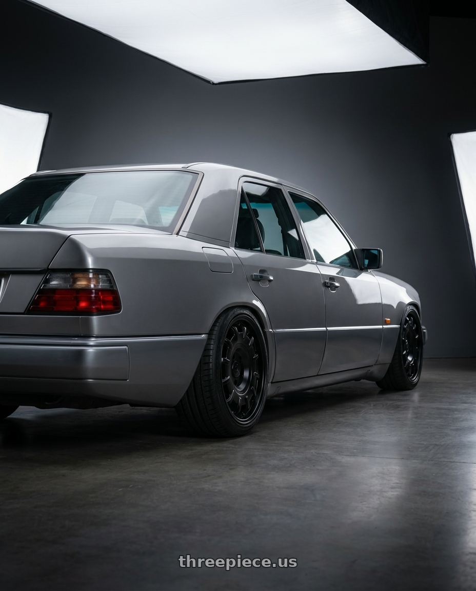 1994 Mercedes E class W124 with fifteen52 BUNDT SV 6x130 17x8 +40 ASPHALT BLACK (SATIN BLACK) wheels rear three quarter view slight stretch tires