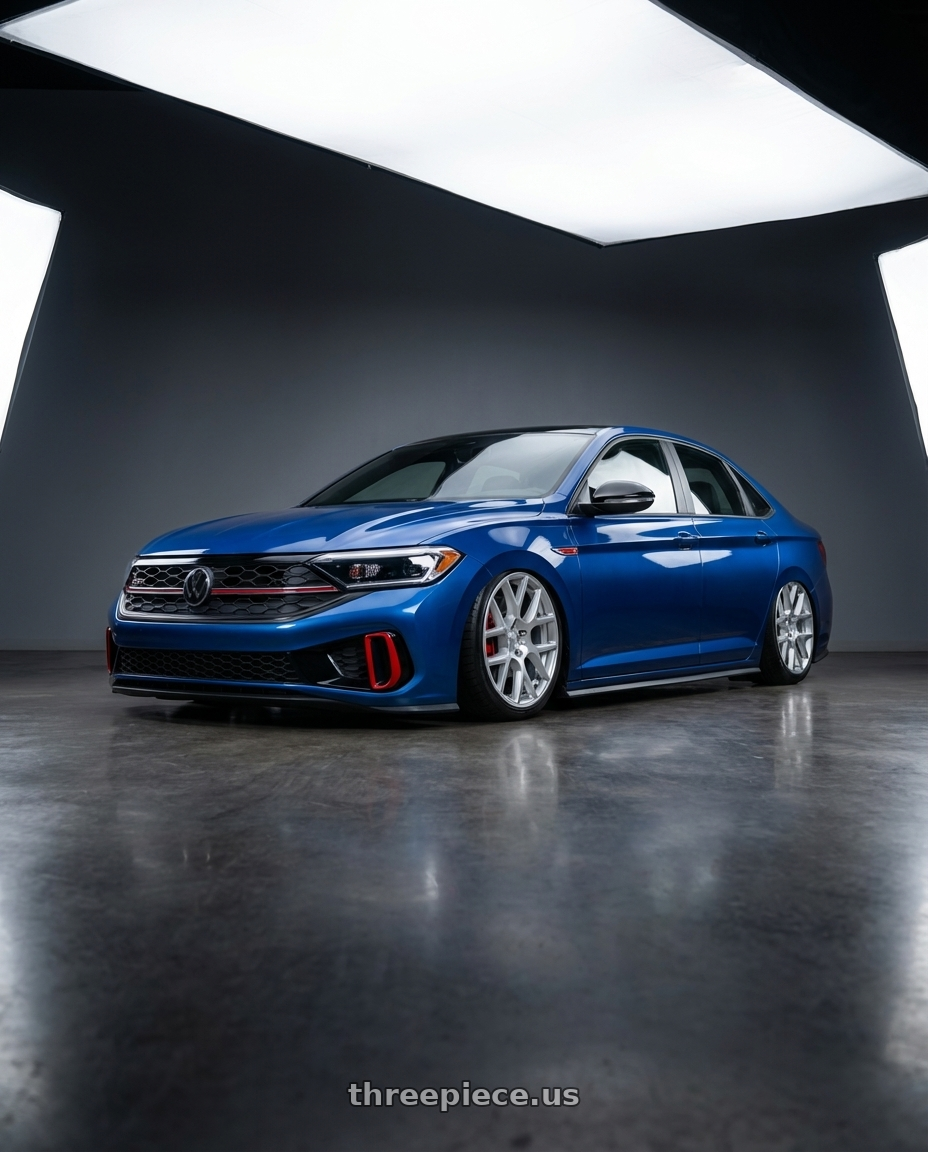 2024 Volkswagen Jetta gli blue with Rotiform 1PC R120 SPF 5X112 19X8.5 +45 GLOSS SILVER MACHINED wheels front three quarter view stanced stance