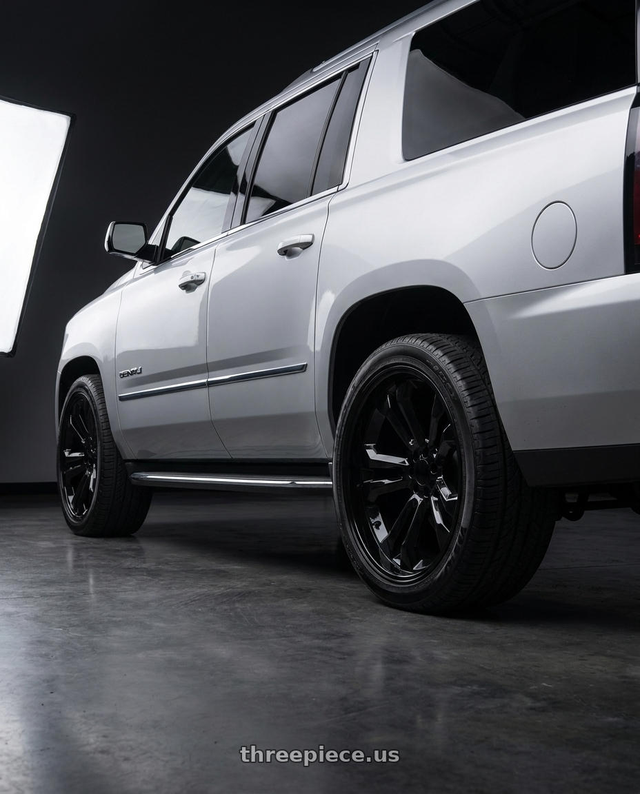 2020 gmc yukon denali xl with O.E. Revolution 158 6x139.7 22x9 +24 Gloss Black wheels rear three quarter view extreme stretch tires