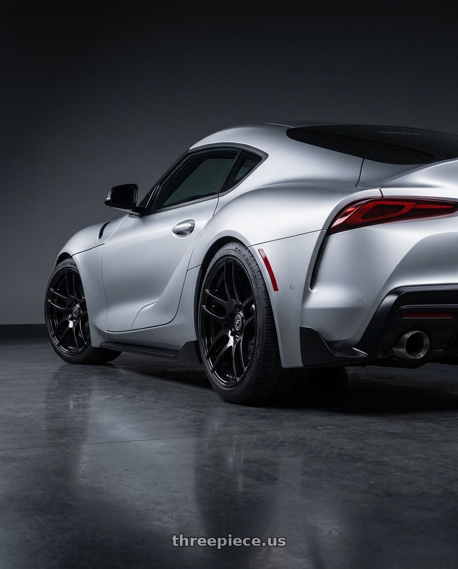 2021 Toyota GR Supra with Forgestar F14 5x112 18x8.5 +35 Gloss Black wheels rear three quarter view staggered tires