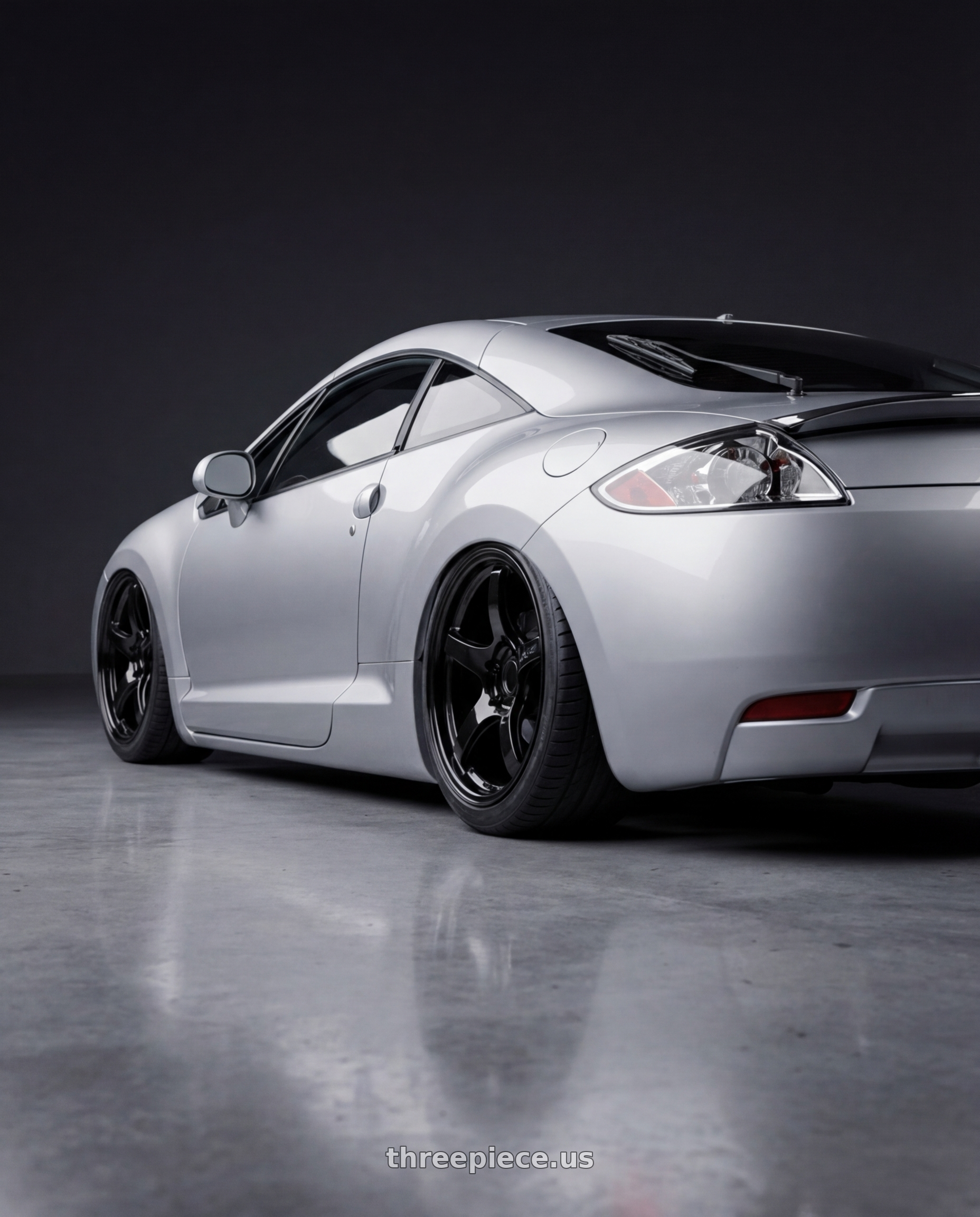 2010 Mitsubishi Eclipse with Gram Lights 57CR 5x114.3 19x8.5+45 Glossy Black wheels rear three quarter view slight stretch tires