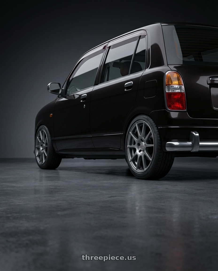 2000 Daihatsu Mira Gino  with Vision Street-Designs 18 Hellion 4x100 15x6.5+38 Gunmetal wheels rear three quarter view slight stretch tires