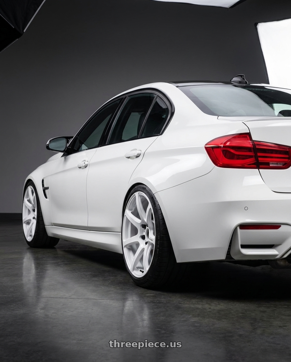 2018 bmw M3 Alpine white with Work Emotion T7R wheels rear three quarter view slight stretch tires