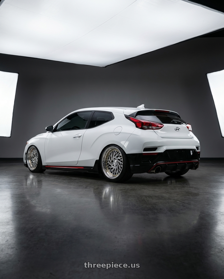 2022 Hyundai Veloster N, chalk white with Aodhan DS03 5x114.3 18x9.5 +30 Vacuum Chrome w/Gold Rivets wheels rear three quarter view square tires