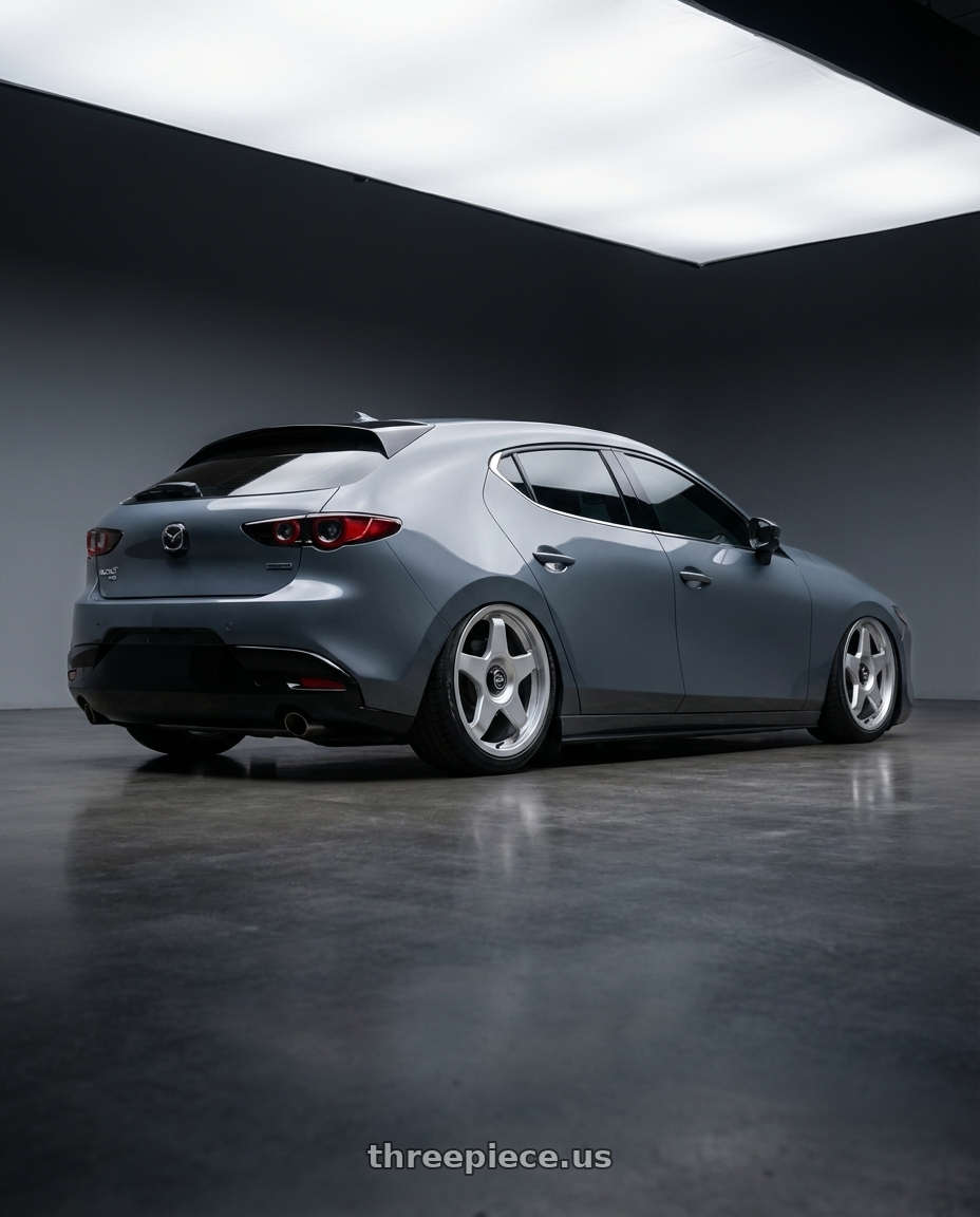 2023 Mazda Mazda3 Turbo with fifteen52 CHICANE 5x114.3 / 5x100 18x8.5 +35 SPEED SILVER (GLOSS SILVER) wheels rear three quarter view slight stretch tires