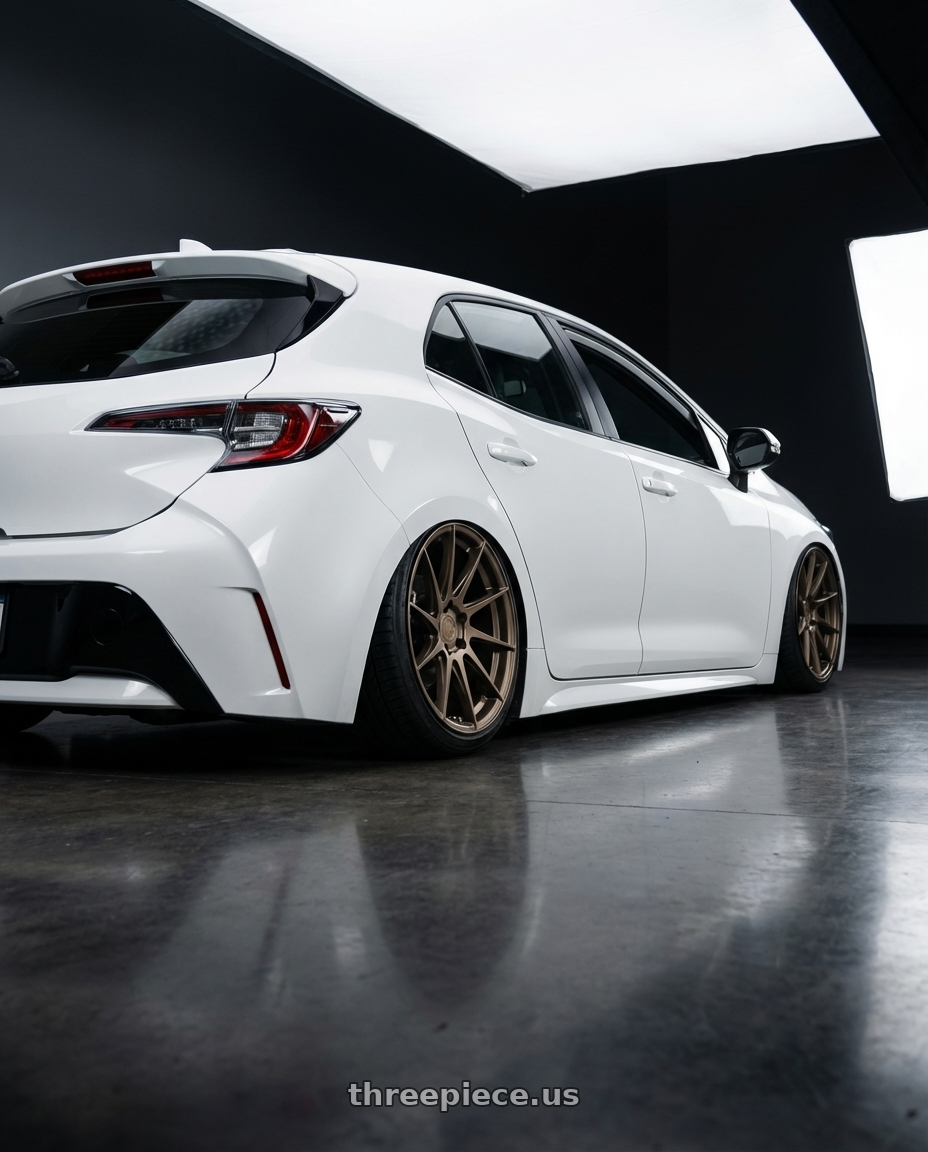 2023 Toyota Corolla Hatchback with Aodhan AH09 5x114.3 18x9.5 +35 Matte Bronze wheels rear three quarter view slight stretch tires