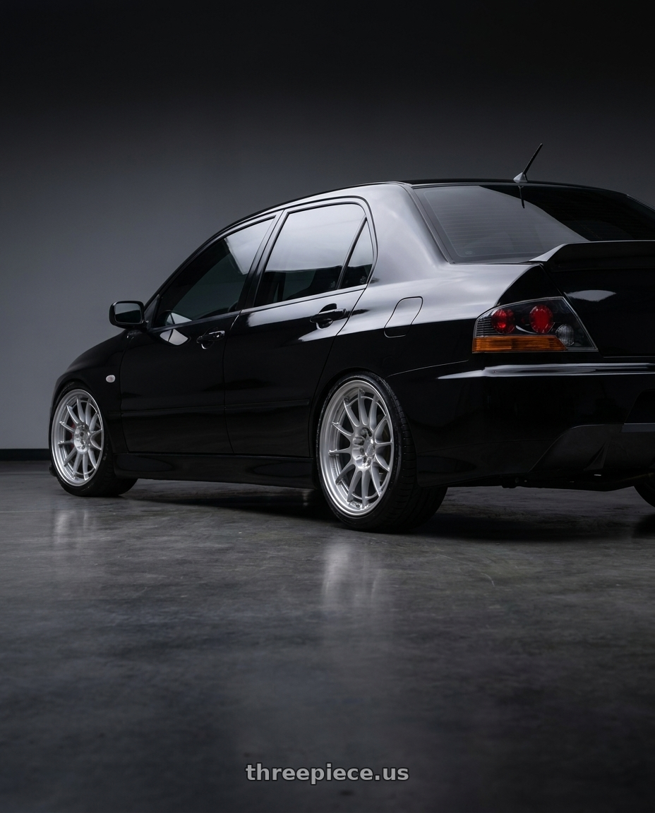 2005 Mitsubishi Lancer evolution with Enkei NT03+M 5x114.3 18x8.5+38 Silver wheels rear three quarter view slight stretch tires