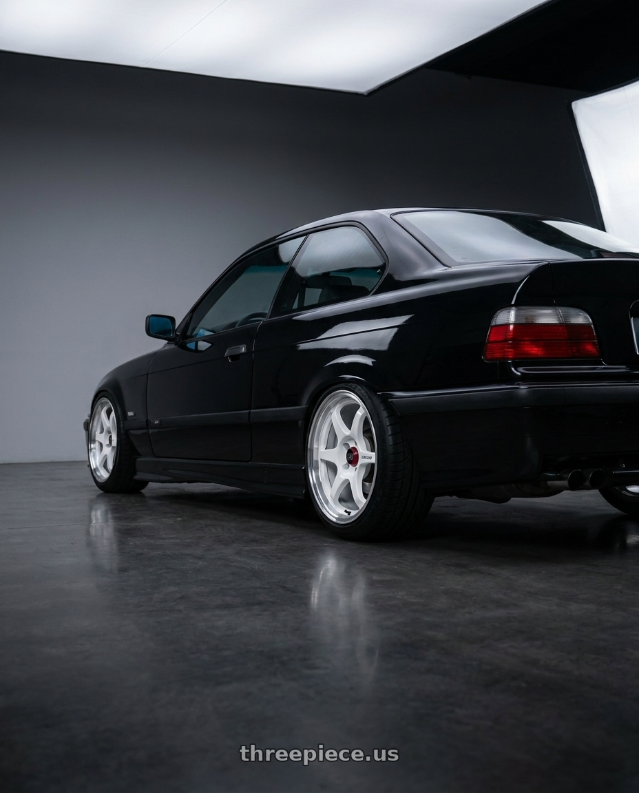 1993 BMW E36 325i coupe with Enkei PF06 4x100 15x8+25 White Machined wheels rear three quarter view slight stretch tires