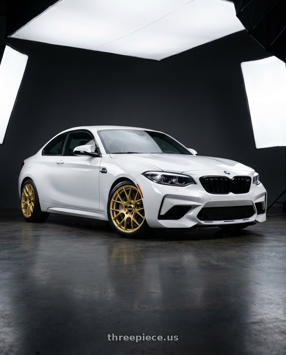2019 BMW M2 Competition with BBS RE-V7 5x120 19x9.5 +25 Gold wheels front three quarter view stock stance