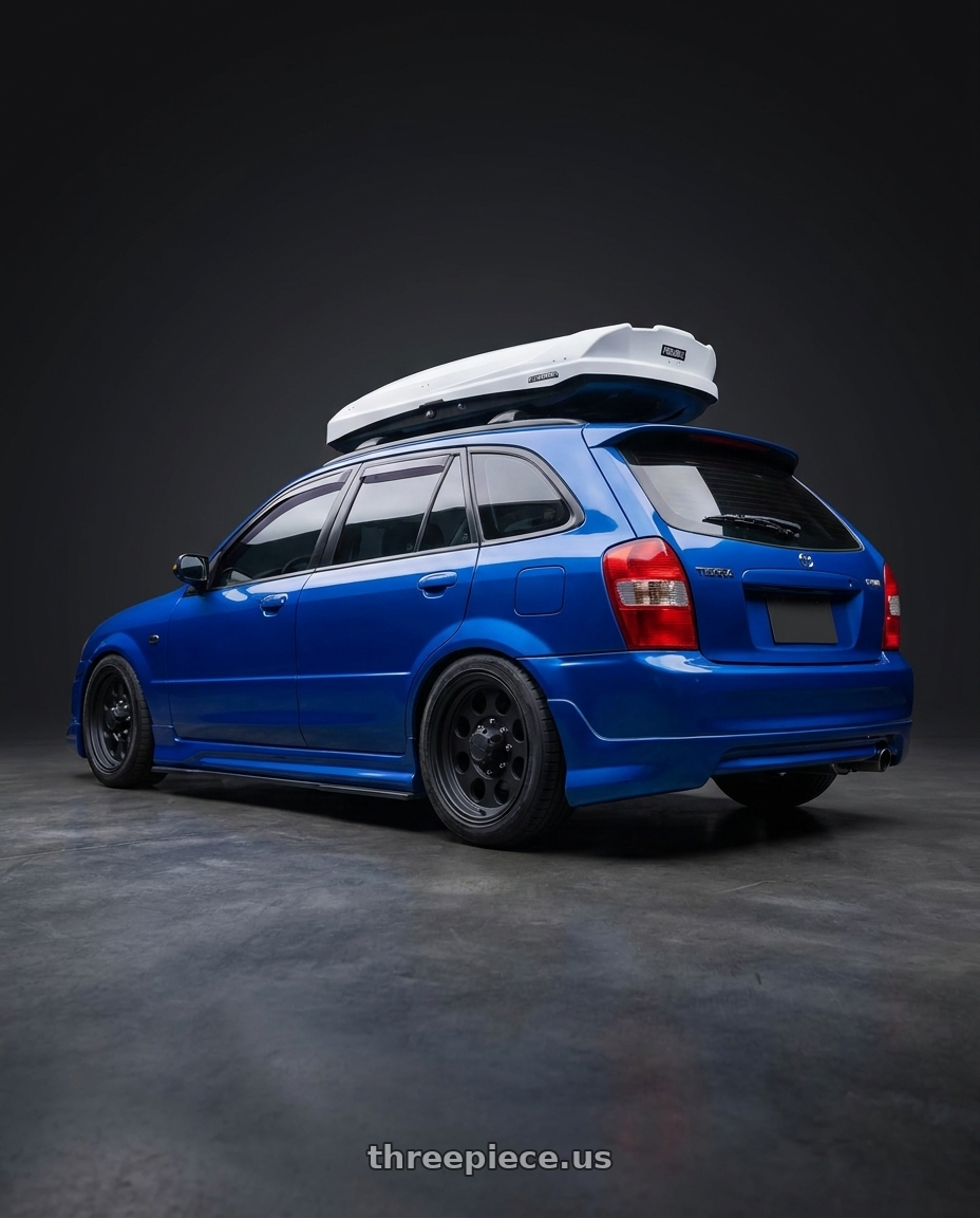 2000 Ford Tierra 323 with Pacer 164B LT Mod Black 6x139.7 15x8 -19 Matte Black wheels rear three quarter view square tires