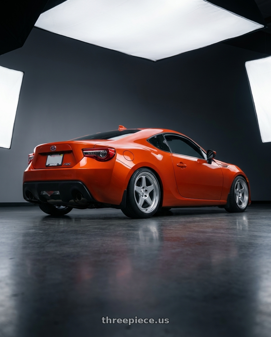 2015 Scion FRS Hot Lava with Kansei K12H KNP 5X100 17x9 35 Hyper Silver wheels rear three quarter view square tires