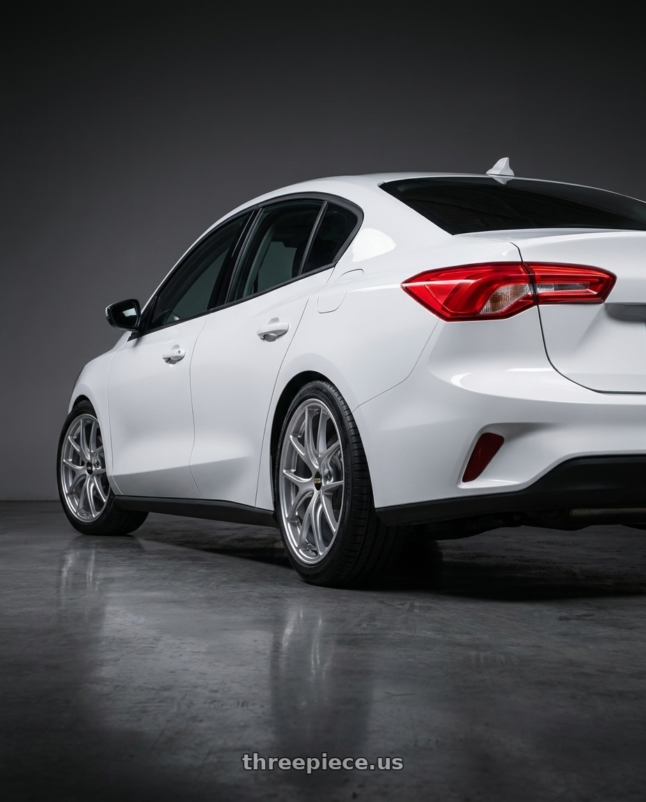 2019 Ford Focus Sedan with BBS RI-A 5x130 18x8.5+48 Diamond Silver wheels rear three quarter view square tires