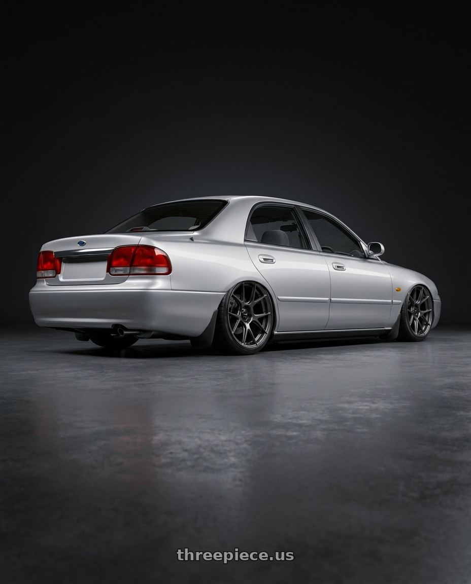 1997 Ford telstar with Konig Ampliform 5x120 20x8.5+45 Dark Metallic Graphite wheels rear three quarter view slight stretch tires