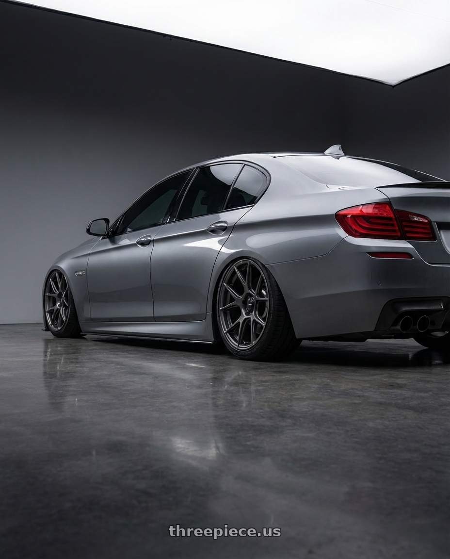 2016 BMW 5 Series F10 with Konig Ampliform 5x120 20x8.5+45 Dark Metallic Graphite wheels rear three quarter view slight stretch tires
