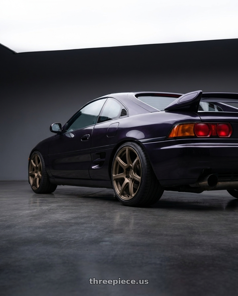 1998 toyota mr2 with Work Emotion T7r 5x100 18x9.5 +22 Matte Bronze wheels rear three quarter view slight stretch tires