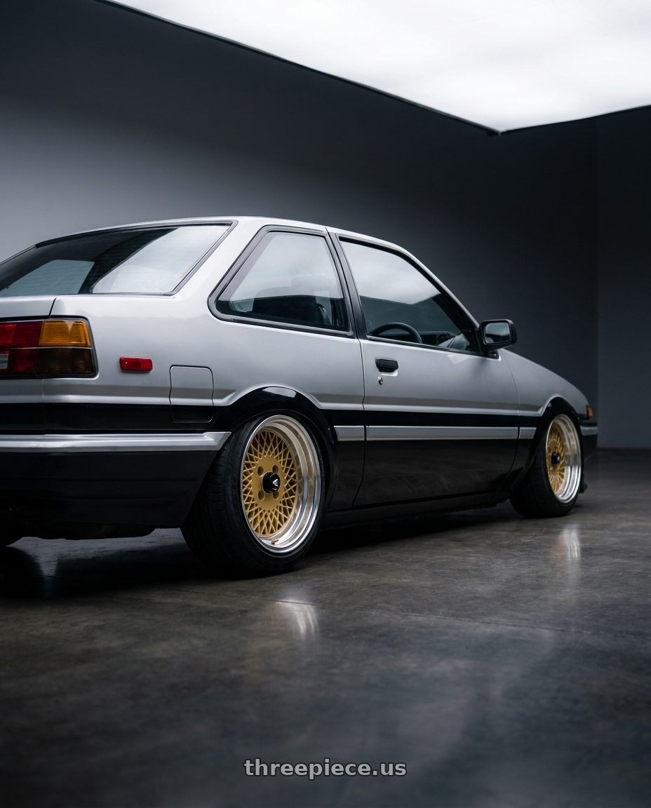 1986 Toyota Corolla  with Enkei Enkei92 Classic Line 4x114.3 15x7+38 Gold wheels rear three quarter view slight stretch tires