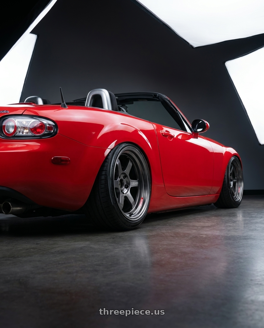 2007 Mazda Miata with Volk Racing TE37V PRO 5x114.3 17x10.5+0 Pressed Graphite wheels rear three quarter view extreme stretch tires