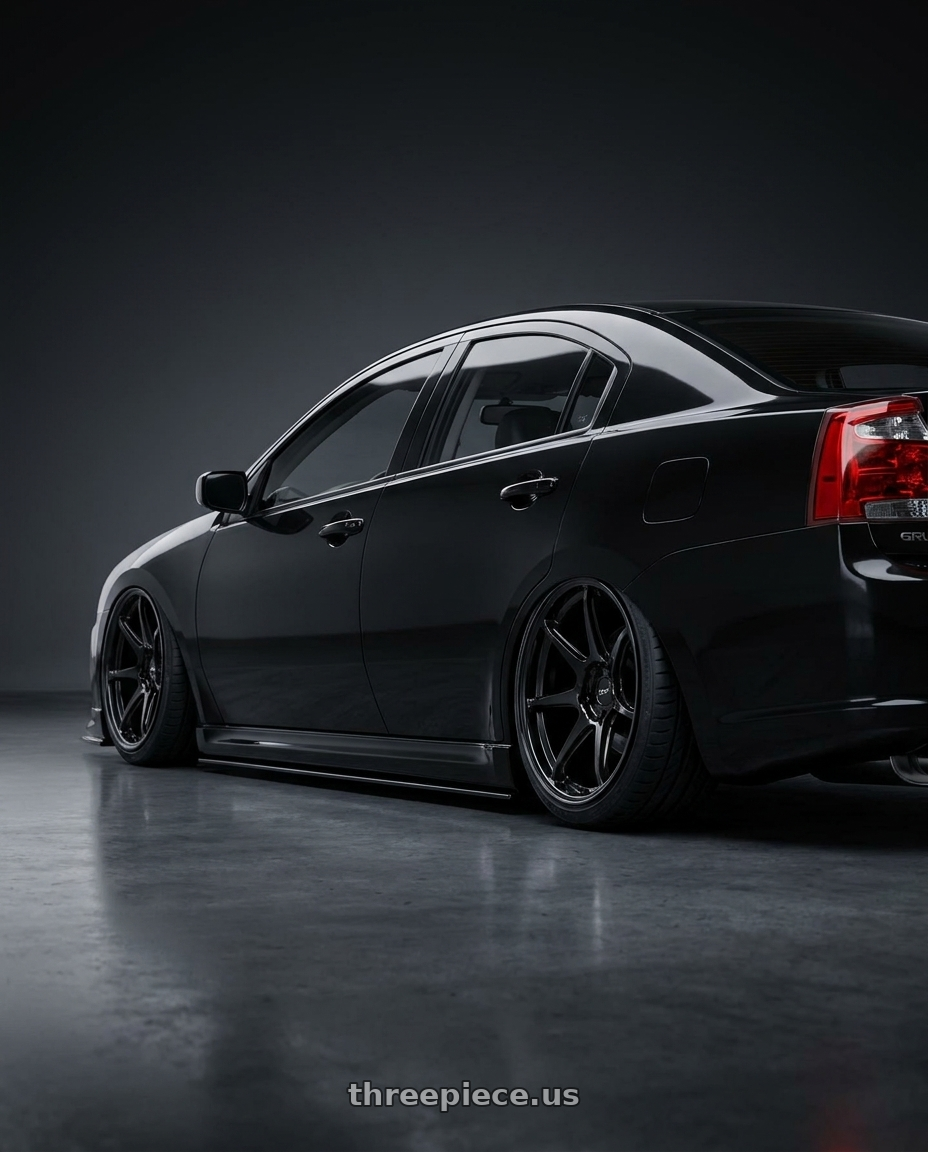 2010 Mitsubishi Grunder with Enkei TM7 5x114.3 18x9.5+38 Gloss Black wheels rear three quarter view slight stretch tires