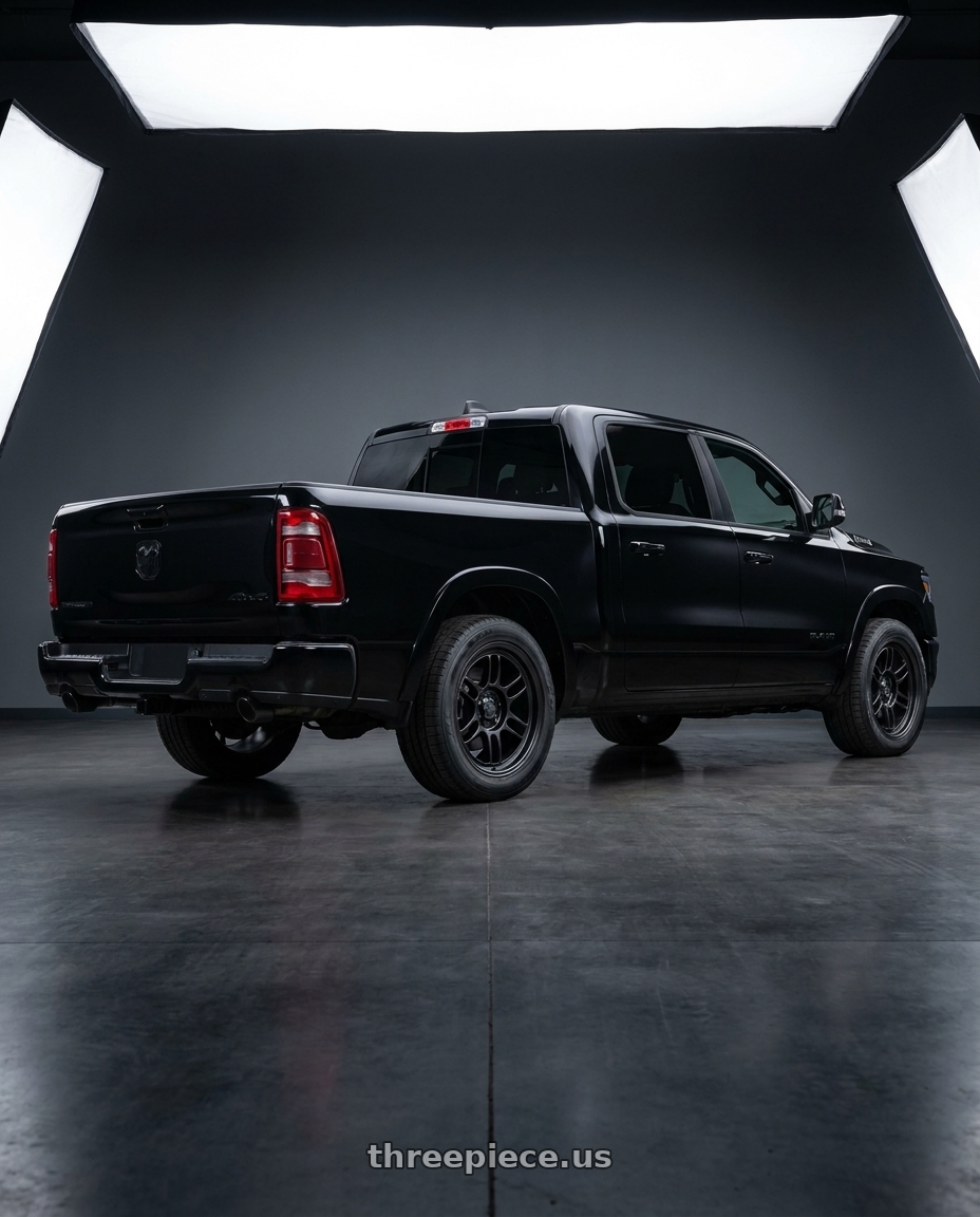 2026 Ram 1500 with Enkei RPT1 6x139.7 18x9+0 Black wheels rear three quarter view square tires